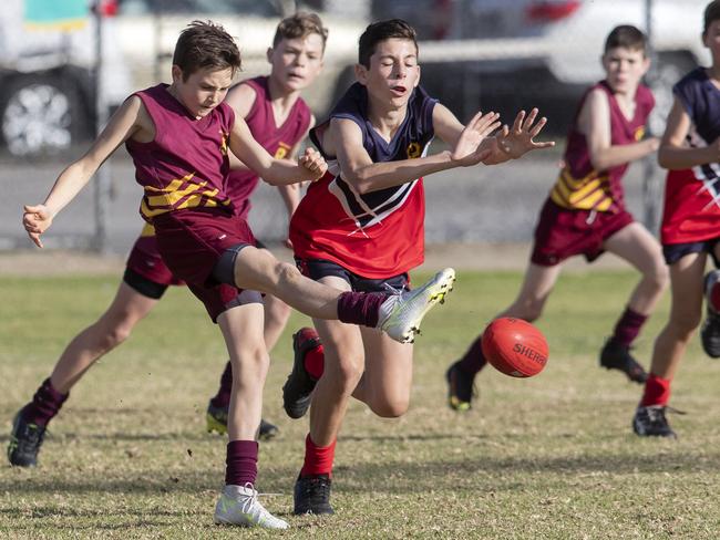 day three of the School Sport SA Sapsasa Country Football Carnival - Year 7 Division 1: Upper South East (red/blue) v Gawler (maroon) at West Beach , 2 June 2021. Picture Simon Cross