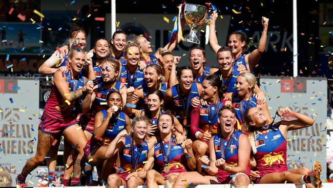 MELBOURNE, AUSTRALIA - DECEMBER 03: The Lions celebrate on the dais after winning during the 2023 AFLW Grand Final match between The North Melbourne Tasmanian Kangaroos and The Brisbane Lions at IKON Park on December 03, 2023 in Melbourne, Australia. (Photo by Michael Willson/AFL Photos via Getty Images)