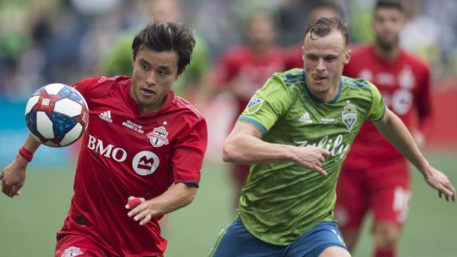 Seattle Sounders defender Brad Smith, right, confronts Toronto FC forward Tsubasa Endoh in the MLS Cup final in Seattle