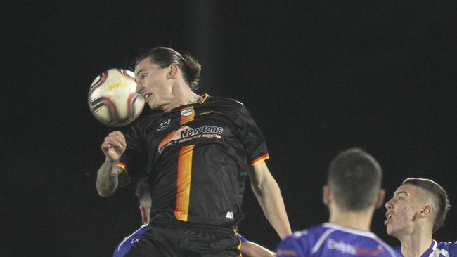 MetroStars’ Liam Wooding heads the ball away from goal in the 4-0 win over West Adelaide. (AAP Image/Dean Martin)