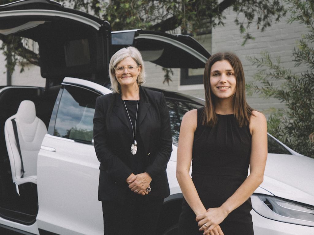 Regular passenger Sam Mostyn (left) with Evoke founder Pia Peterson (right) and a Tesla limousine. Picture: Supplied.