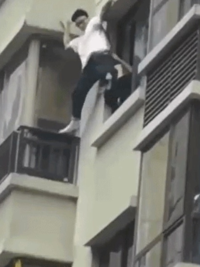 Authorities haul him in through the third story window.