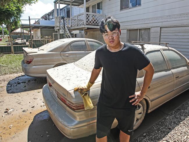 Nhat Pham stands out the front of his Layard Street home in Goodna as he starts the clean up. Picture: Zak Simmonds