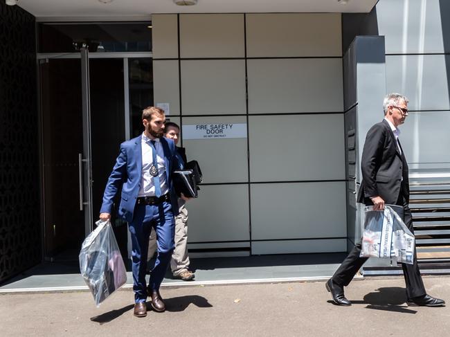 Police leaving the Pyrmont home of the Pandelis after a raid in 2018.