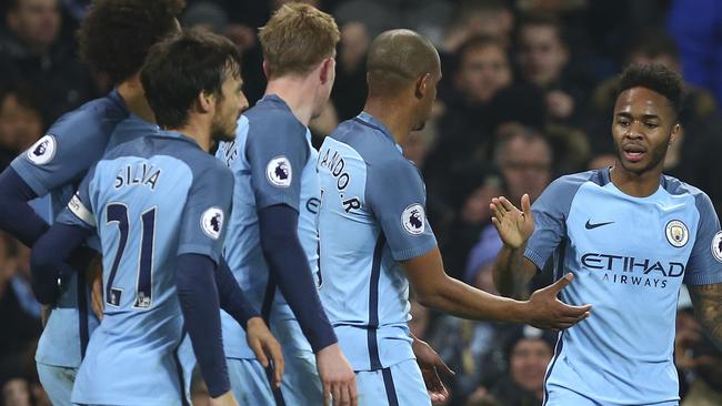 Manchester City's Raheem Sterling, right, celebrates.