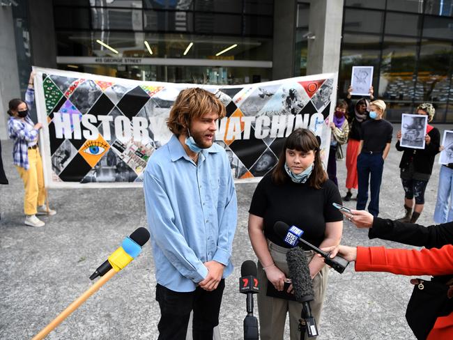 Jarrah Kershaw (left) and Laura Harland are flanked by supporters as they talk to the media outside the District Court in Brisbane. The two were named as the organisers of the Story Bridge sit-in pro refugee protest in an injunction application by the Attorney-General. Picture: NCA NewsWire/Dan Peled