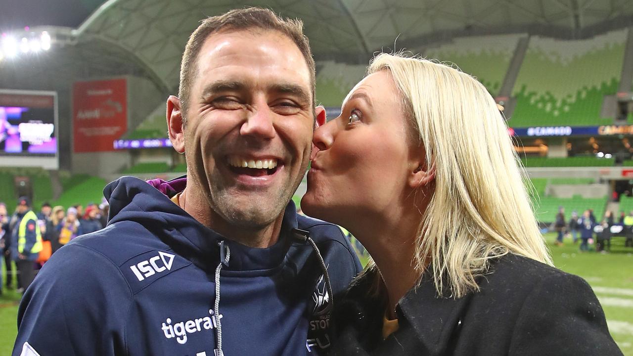 Melbourne Storm captain Cameron Smith is kissed by his wife Barbara Smith as he leaves the field after becoming the first player to reach 400 matches.