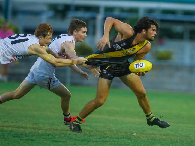 Luca Goonan (right) is tackled while playing for Nightcliff in Darwin. Picture GLENN CAMPBELL