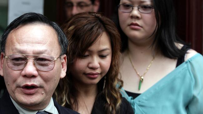 Quang Huynh leaves the Supreme Court with his daughters after the verdict was handed down in the trial of seven men over the deaths of his sons after a fight erupted at Salt nightclub, South Yarra in 2002. Picture: AAP Image/Glenn Hunt