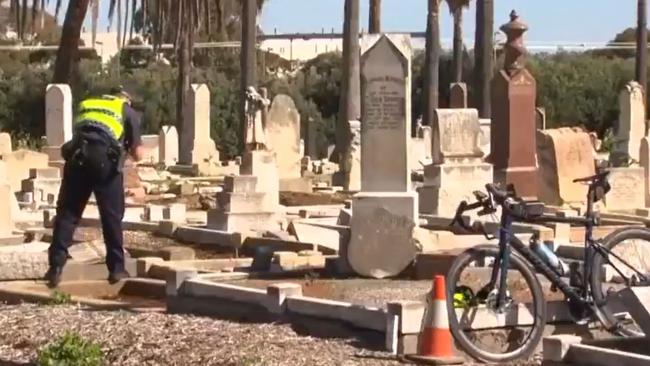 Police in the West Terrace Cemetery after a cyclist fell down stairs. Picture: 7NEWS