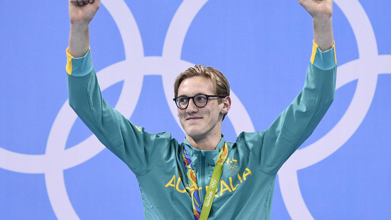 Australia's Mack Horton celebrates on the podium with his gold medal after he won the Men's 400m Freestyle Final during the swimming event at the Rio 2016 Olympic Games at the Olympic Aquatics Stadium in Rio de Janeiro on August 6, 2016. / AFP PHOTO / Martin BUREAU