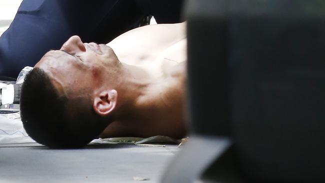 James Gargasoulas lies on the ground on Bourke St after being shot by police. Picture: David Caird