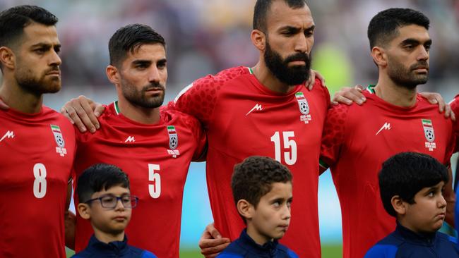 Iranian players Morteza Pouraliganji, Milad Mohammadi and Roozbeh Cheshmi of IR Iran line up for the national anthem before the FIFA World Cup Qatar 2022 Group B match between England and IR Iran at Khalifa International Stadium. Picture: Getty Images