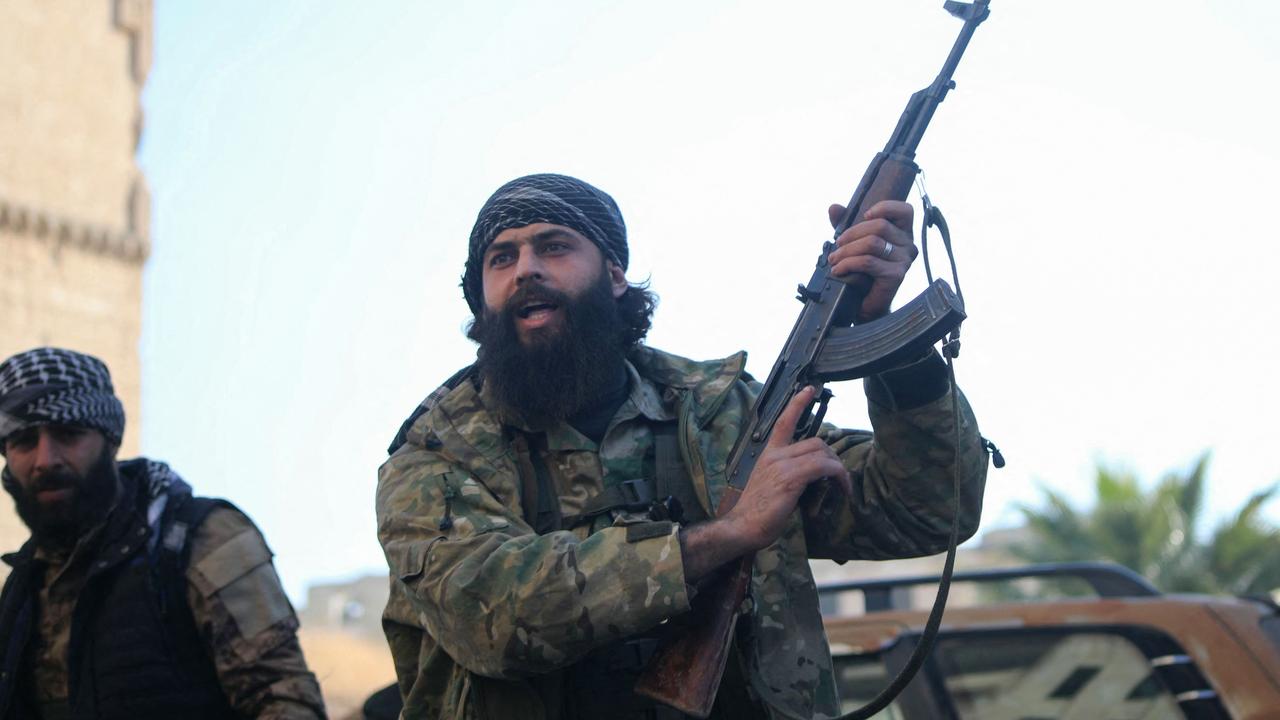 Anti-government fighters celebrate in a street in Maaret al-Numan in Syria's northwestern Idlib province on November 30, 2024. Picture: AFP