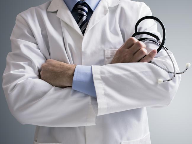 Doctor holding a stethoscope with arms crossed and copy space