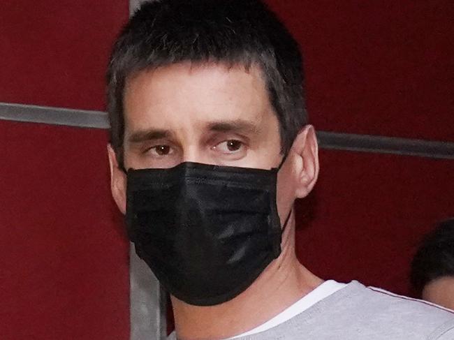 Richard Pusey, the driver of a Porsche who allegedly fled the scene of a truck crash on Melbourne's Eastern Freeway which killed four police officers, is taken away from his Fitzroy property by police in Melbourne, Thursday, April 23, 2020. (AAP Image/Michael Dodge) NO ARCHIVING