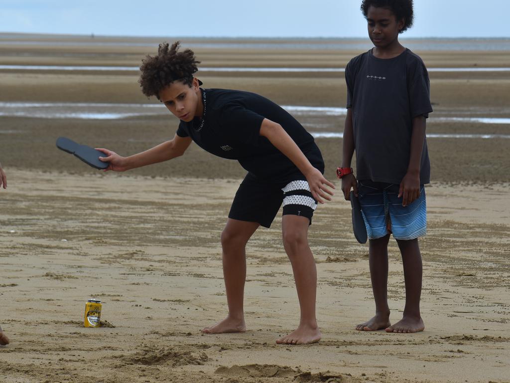 Harper Davis thong-throwing with Esaias Woyse watching at the Mackay & District South Sea islander Association's 2022 Australia Day Celebrations in Quota Park. Picture: Lillian Watkins