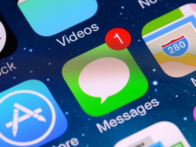 Close-up shot of  iPhone 5 screen displaying home screen, including messages app. istock image
