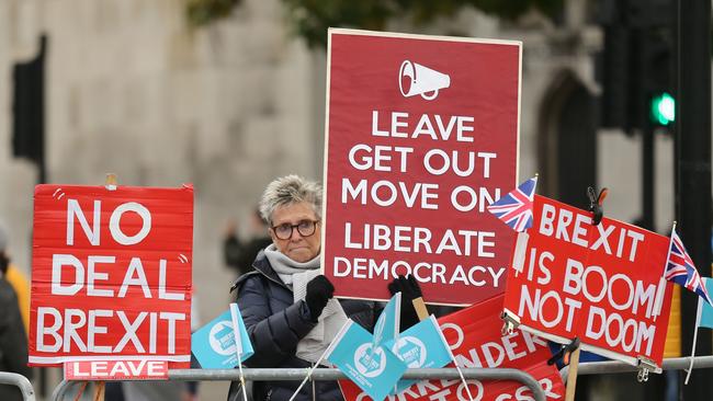 A Pro-Brexit demontrator stands with a placard outside the House of Commons in London yesterday. Picture: AFP