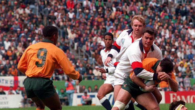 Wallaby David Wilson (ball) held by Ben Clarke during 1995 Rugby World Cup. Pic Col Whelan Action Photographics Sport