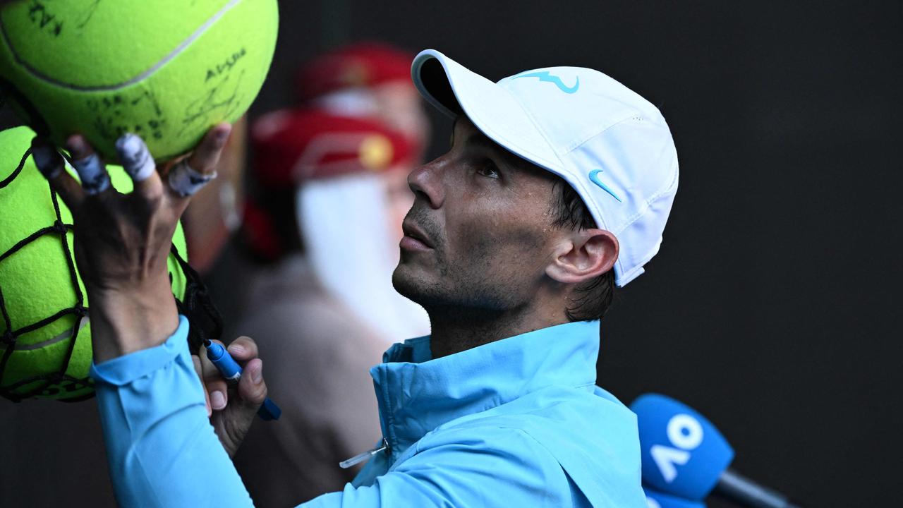 Rafael Nadal signs autographs after his Round 1 win.