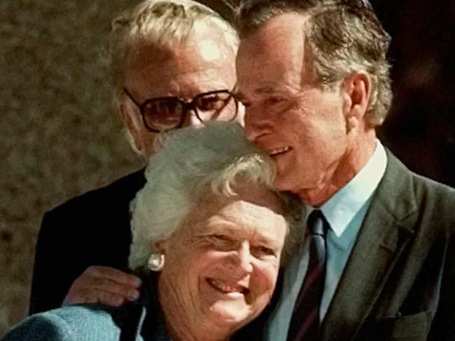 President George Bush hugs his wife, Barbara in 1997.