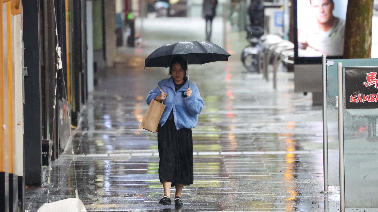 People are braving the wet weather in Melbourne. Picture: NCA NewsWire / Brendan Beckett