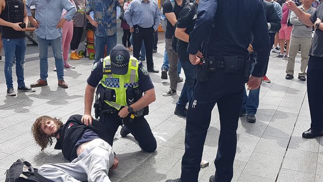 A man is arrested after a busker was hit with a ukulele in Rundle Mall. Picture: Shaun Hollis