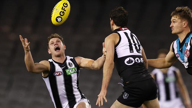 Taylor Adams chases the ball against Port Adelaide in Round 19 at Adelaide Oval. The Magpies had struggled on-field and off-field throughout 2021. Picture: Michael Klein