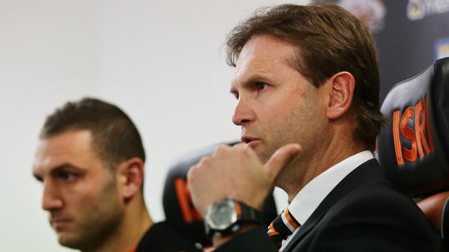 Wests Tigers coach Mick Potter talks during a press conference with Robbie Farah.