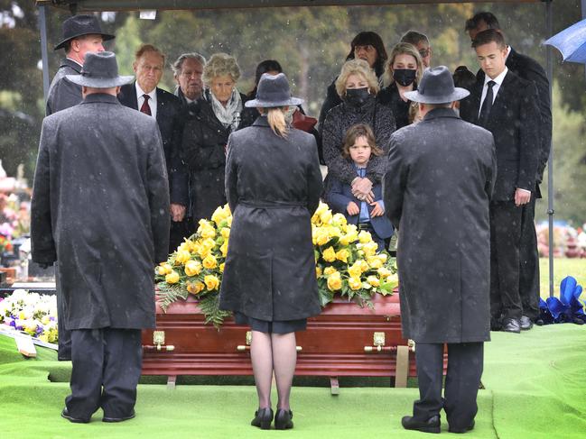 Bert Newton’s family watch on during his burial ceremony. Picture: David Caird