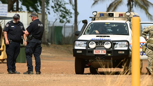 NT Police and Territory Resposnce Group (TRG) officers keep the peace as the community of Angurugu on Groote Eylandt mourns the death of two young males after they were killed by spears as feuding families fought with each other during a mass riot.