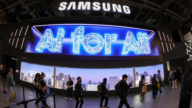 Attendees enter the Samsung booth as a digital message ‘AI for All’ during CES 2024 at the Las Vegas Convention Center. Picture: Ethan Miller/AFP