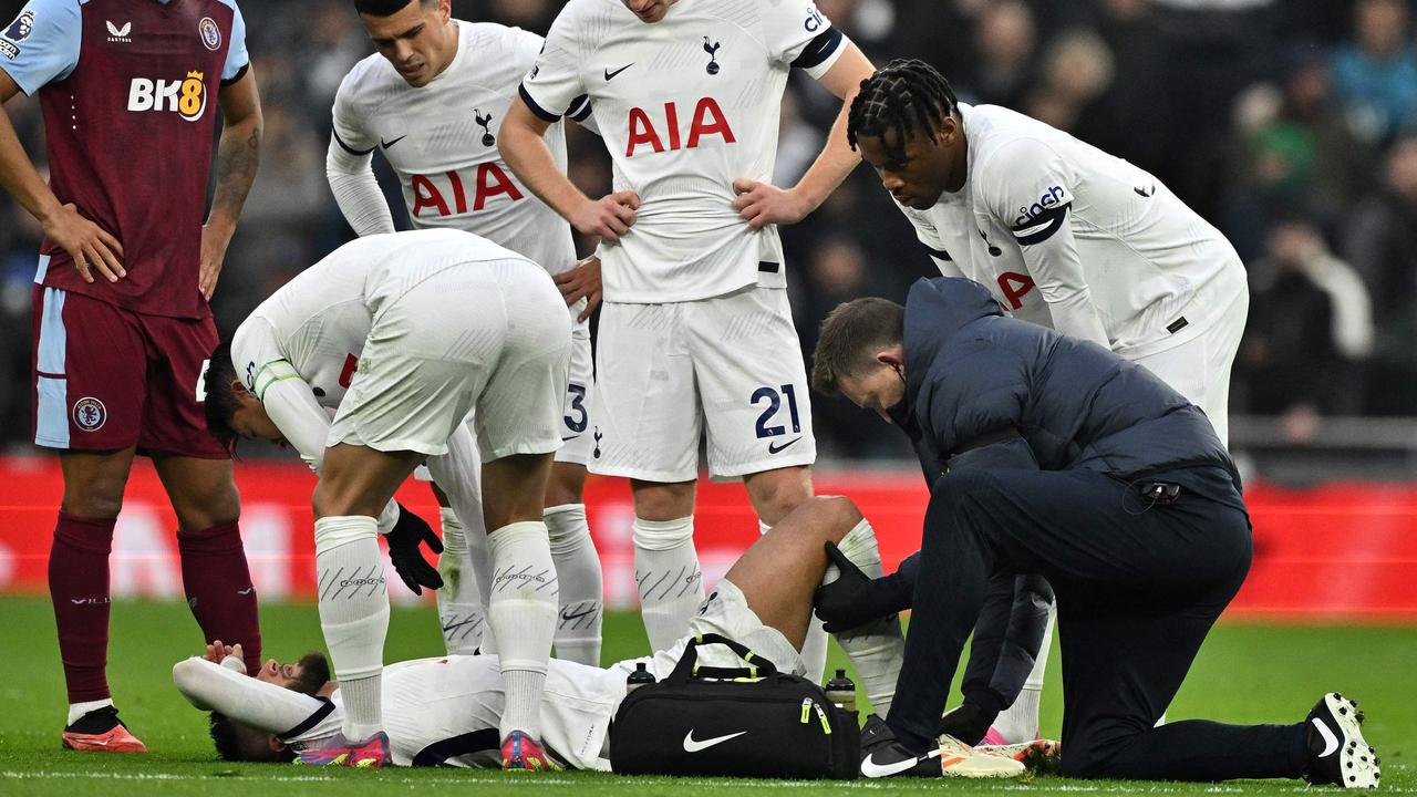 Tottenham Hotspur's Uruguayan midfielder #30 Rodrigo Bentancur receives medical attention during the English Premier League football match between Tottenham Hotspur and Aston Villa at Tottenham Hotspur Stadium in London, on November 26, 2023. (Photo by Ben Stansall / AFP) / RESTRICTED TO EDITORIAL USE. No use with unauthorized audio, video, data, fixture lists, club/league logos or 'live' services. Online in-match use limited to 120 images. An additional 40 images may be used in extra time. No video emulation. Social media in-match use limited to 120 images. An additional 40 images may be used in extra time. No use in betting publications, games or single club/league/player publications. /