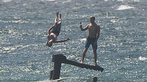 People dive off the remains of the wreck during Schoolies in 2013.