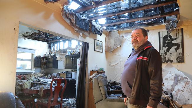 Ken Roberts looks at the devastation in his home after it was destroyed by a fire overnight. Picture: Dean Martin