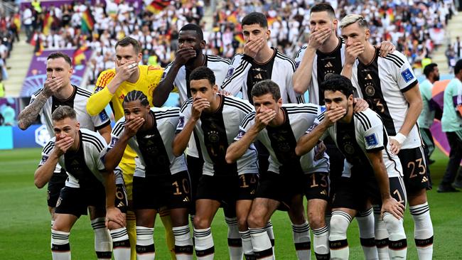 German players cover their mouths in protest before the match against Japan. Picture: Ina Fassbender/AFP