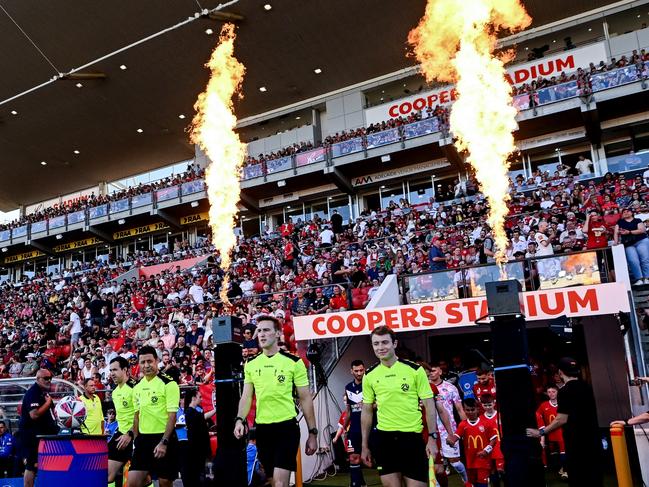 ADELAIDE, AUSTRALIA - JANUARY 18: Referees lead the teams out  during the round 15 A-League Men match between Adelaide United and Melbourne Victory at Coopers Stadium, on January 18, 2025, in Adelaide, Australia. (Photo by Mark Brake/Getty Images)