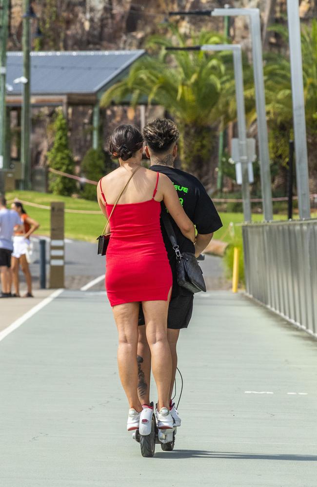 Two people share a scooter at Brisbane Riverwalk. Picture: Richard Walker