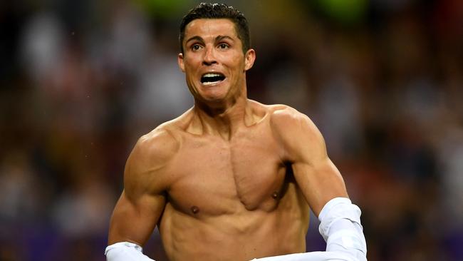 Cristiano Ronaldo of Real Madrid takes off his shirt in celebration.