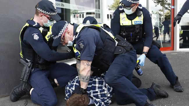 Police arrest a protester in Melbourne. Picture: Darrian Traynor/Getty