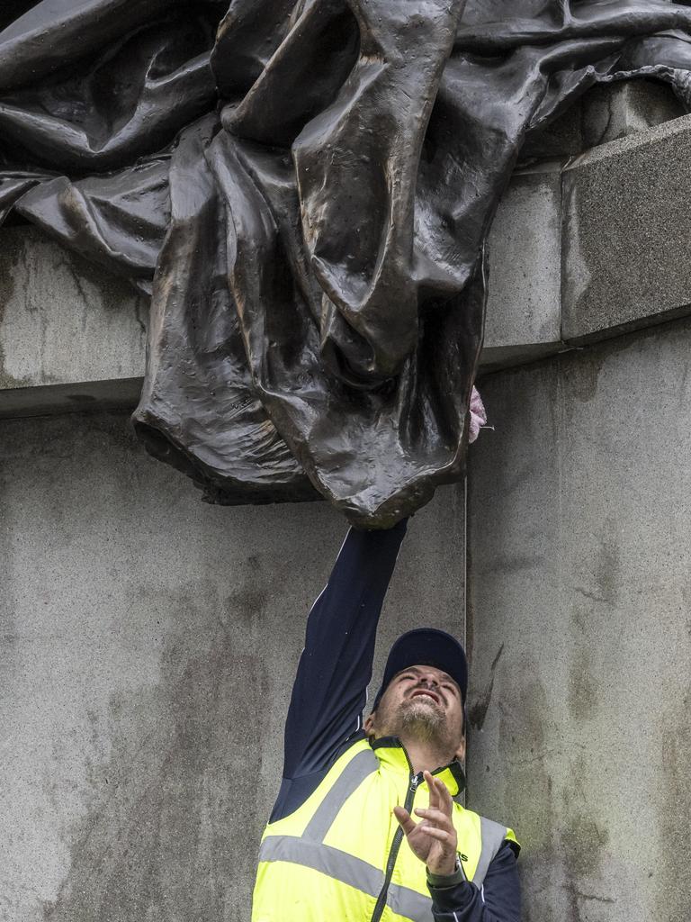 Cleaners worked to clean the iconic statue of Queen Victoria on Tuesday. Picture: NewsWire / Monique Harmer