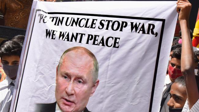 Students hold a placard with the picture of Russia's President Vladimir Putin as they stage a demonstration in Bangalore on March 3, 2022, urging Putin to halt the war on Ukraine and to Indian Prime Minister Narendra Modi to evacuate Indian students and citizens stranded in Ukraine. Picture: Manjunath Kiran / AFP