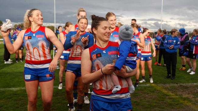 Kirsty Lamb leads the Bulldogs off with nephew Cooper. Picture: Michael Willson/AFL Photos via Getty Images