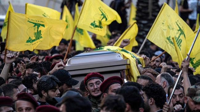 Hezbollah fighters carry the casket of slain top commander Fuad Shukr. Picture: Khaled Desouki/AFP