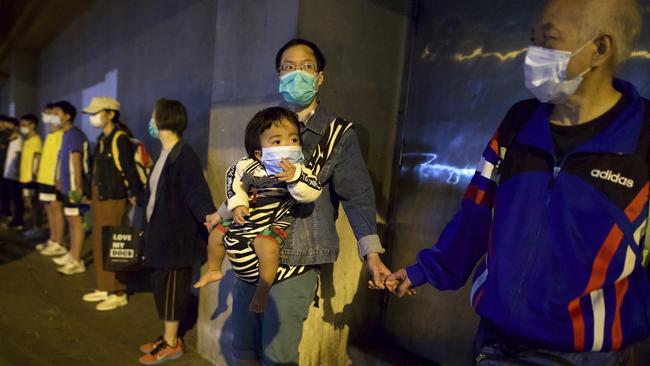 Older protesters join hands to form a human chain during a rally in Hong Kong on Saturday. Picture: AP