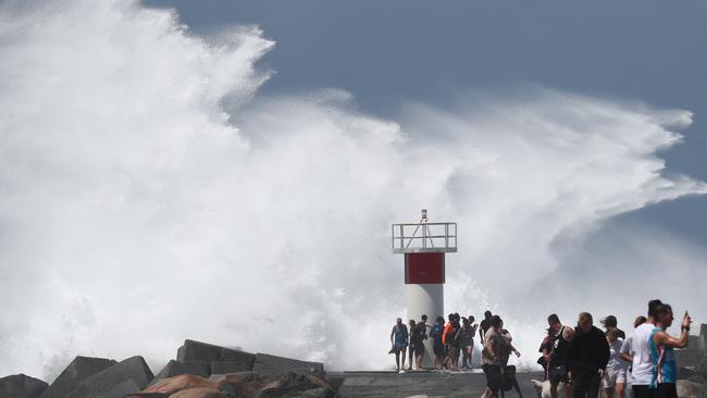 People at The Gold Coast Seaway as Cyclone Oma whips up wild conditions. Photograph: Jason O'Brien