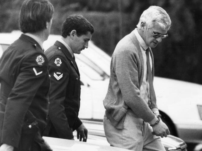 Von Einem is led handcuffed to testify at the trial of former vice squad officers charged with unlawful killing of Dr George Duncan.