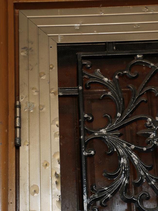 Shotgun pellet holes seen on the door frame of Stacey Taylor’s home.