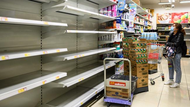 Empty shelves are left where toilet paper was once stocked at a supermarket in Hong Kong. Picture: AFP